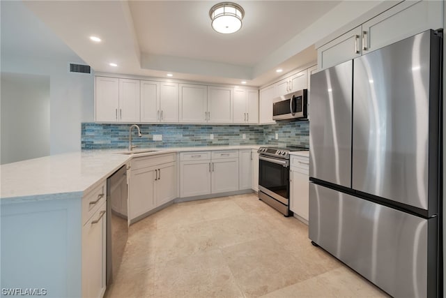 kitchen with white cabinetry, tasteful backsplash, and stainless steel appliances