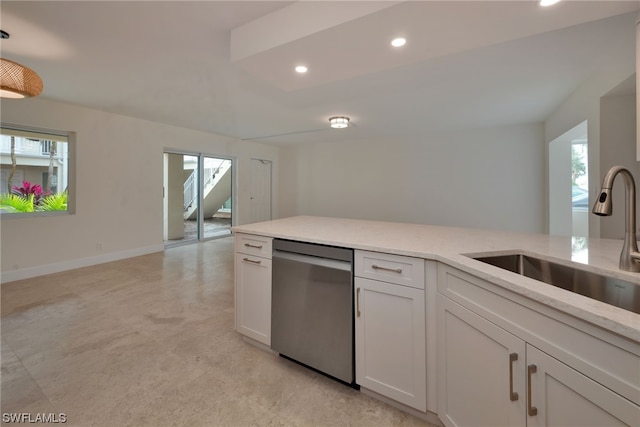 kitchen featuring sink, hanging light fixtures, white cabinets, stainless steel dishwasher, and light stone countertops