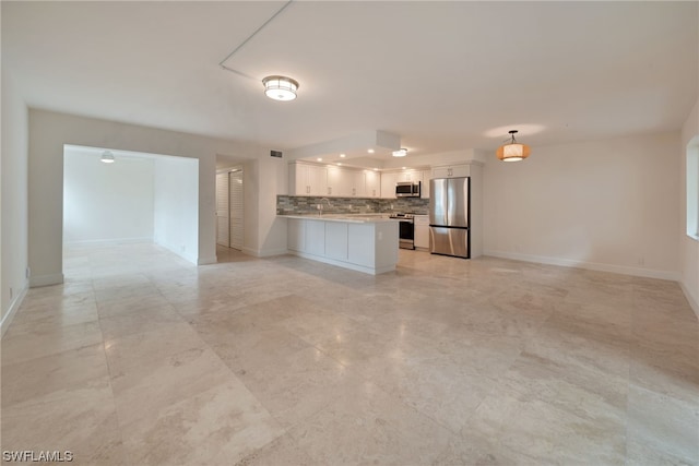 unfurnished living room featuring sink and light tile floors