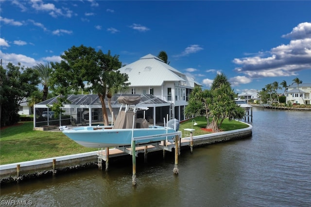 back of property featuring a water view, a lanai, and a lawn