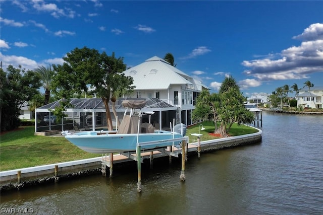 back of property featuring a water view, glass enclosure, and a lawn