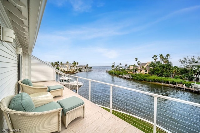 balcony featuring a water view and outdoor lounge area