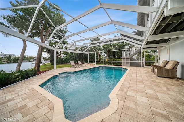 view of swimming pool featuring a patio and glass enclosure