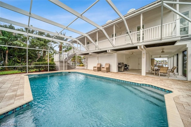 view of swimming pool with a grill, a lanai, a patio area, and ceiling fan