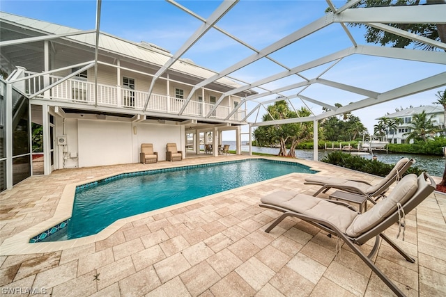 view of pool featuring a patio and glass enclosure