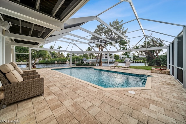 view of swimming pool featuring a lanai and a patio area