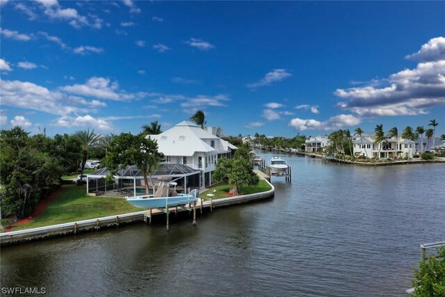 view of dock featuring a water view, glass enclosure, and a lawn