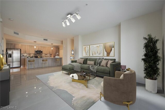 tiled living room featuring rail lighting