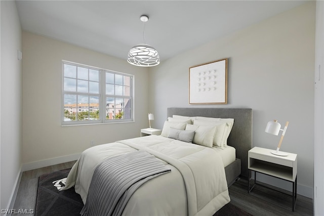 bedroom with dark wood-type flooring