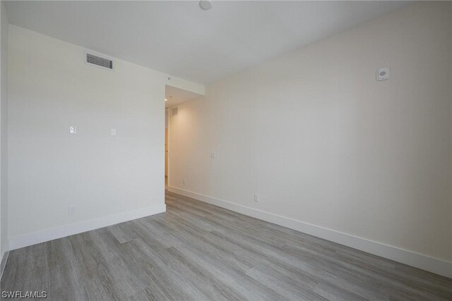 unfurnished room with light wood-type flooring