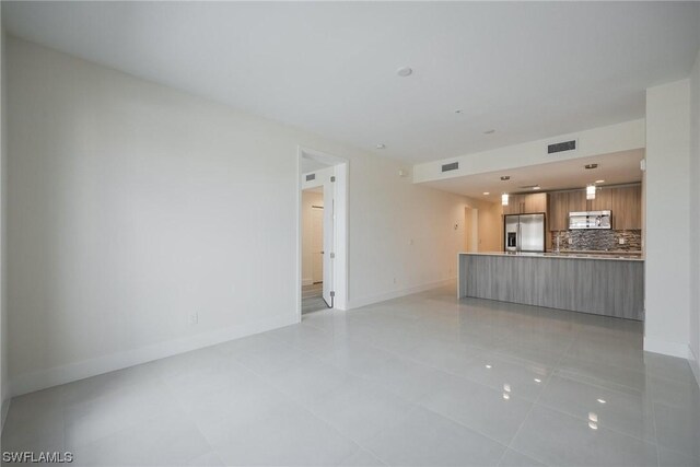 unfurnished living room with light tile patterned flooring