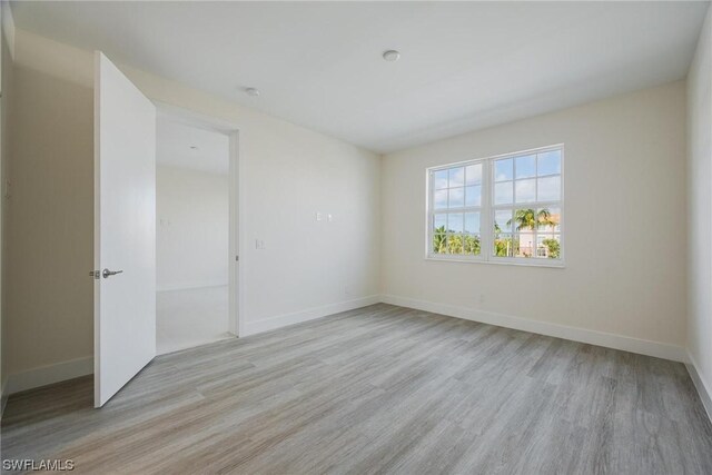 empty room with light hardwood / wood-style flooring