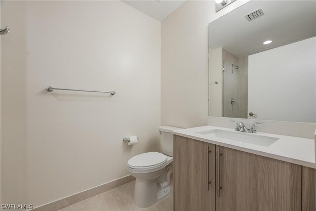 bathroom with tile patterned floors, toilet, and vanity