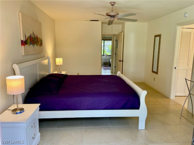 tiled bedroom featuring ceiling fan