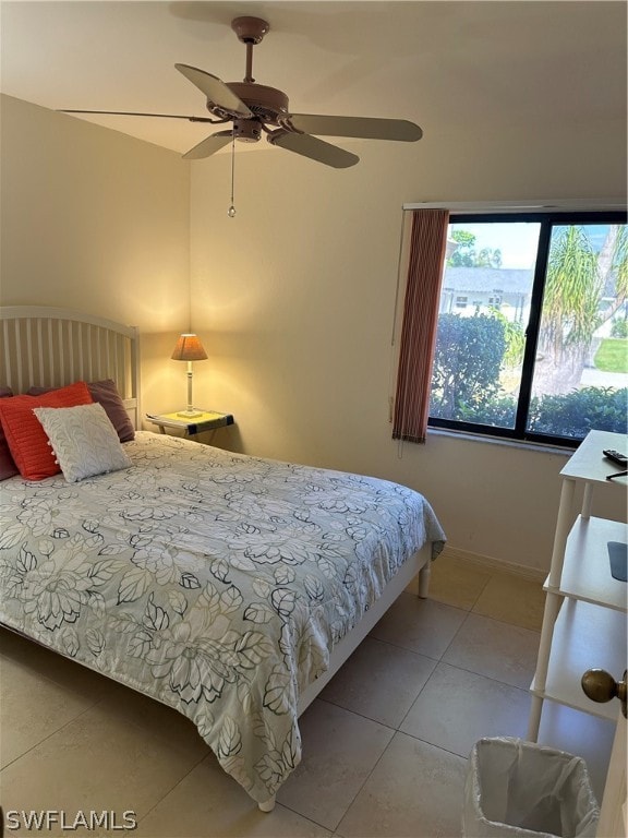 tiled bedroom featuring ceiling fan