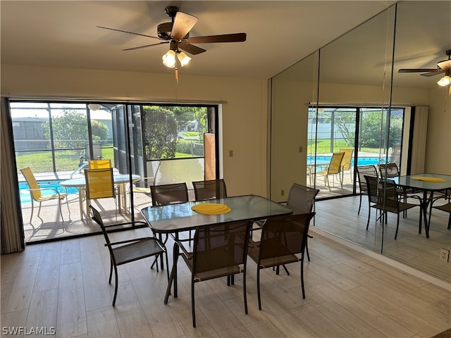 dining room with plenty of natural light, wood-type flooring, and ceiling fan