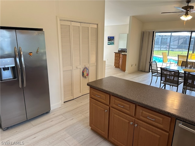 kitchen featuring light hardwood / wood-style flooring, ceiling fan, and stainless steel fridge