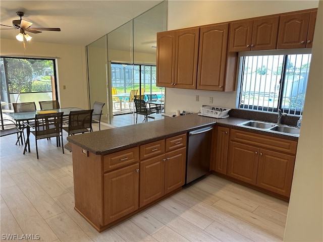 kitchen with light hardwood / wood-style flooring, kitchen peninsula, sink, stainless steel dishwasher, and ceiling fan