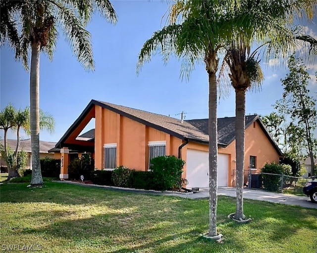 view of front of home with a front lawn and a garage