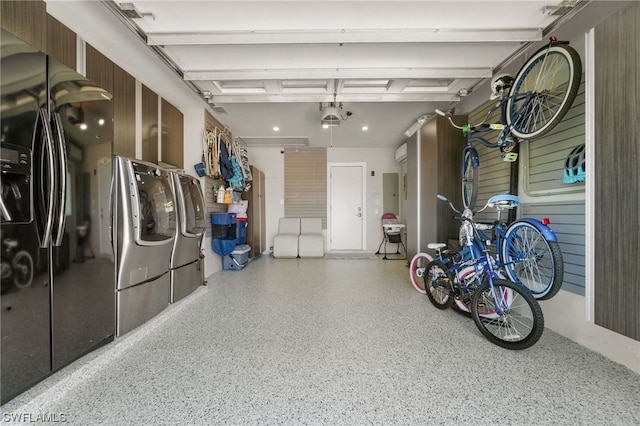 garage with electric panel and independent washer and dryer