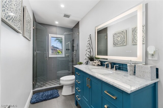 bathroom with vanity, walk in shower, tile patterned floors, and toilet