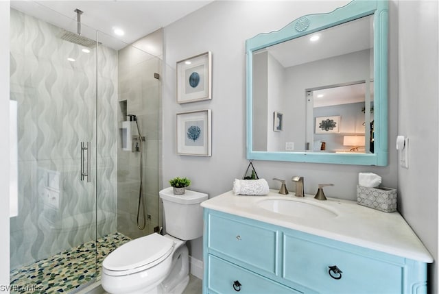 bathroom featuring vanity, toilet, and an enclosed shower