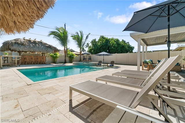 view of pool with exterior bar and a patio area