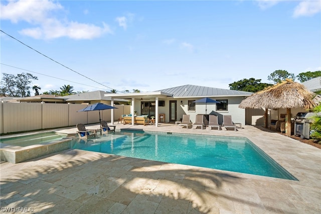 view of pool with a patio area, an outdoor hangout area, and an in ground hot tub