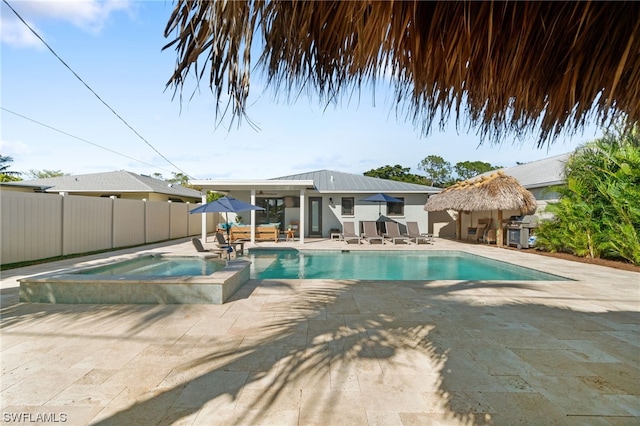 view of swimming pool with an in ground hot tub and a patio area