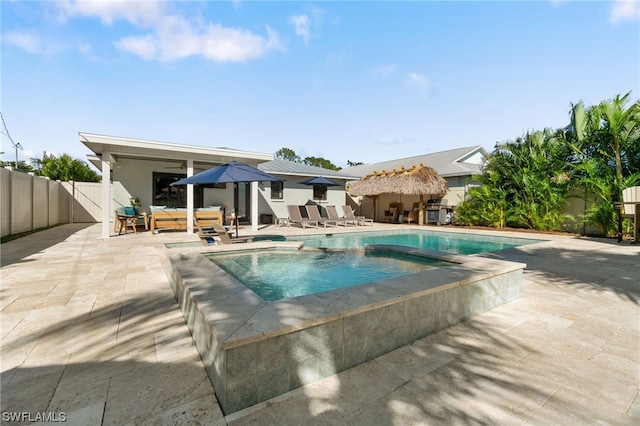 view of pool featuring ceiling fan, an outdoor living space, and a patio