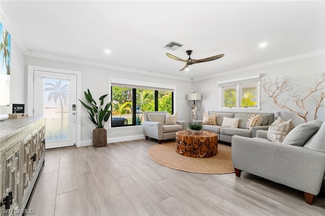 living room featuring ceiling fan, ornamental molding, and light hardwood / wood-style flooring