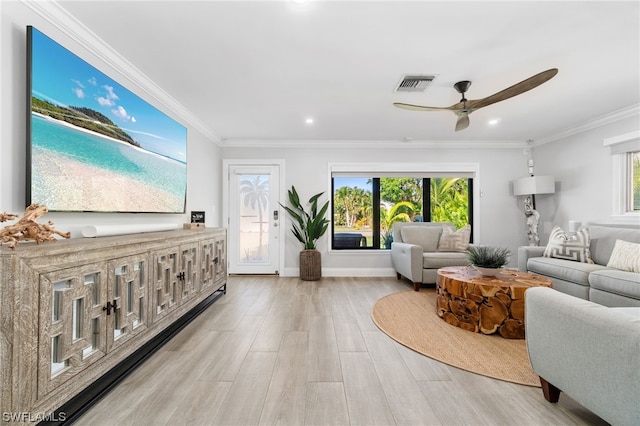 living room featuring crown molding, plenty of natural light, ceiling fan, and light hardwood / wood-style flooring