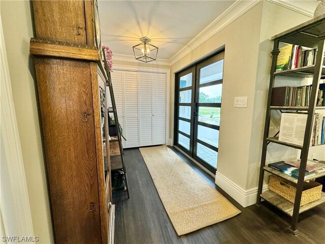 entrance foyer with ornamental molding and hardwood / wood-style floors