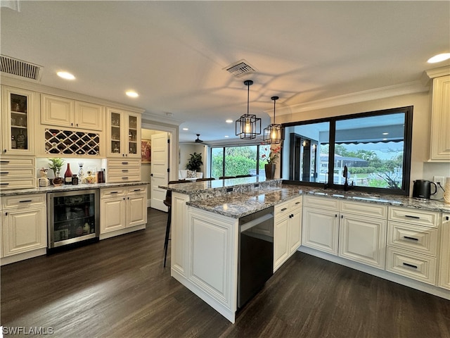 kitchen with crown molding, kitchen peninsula, wine cooler, dark wood-type flooring, and decorative light fixtures