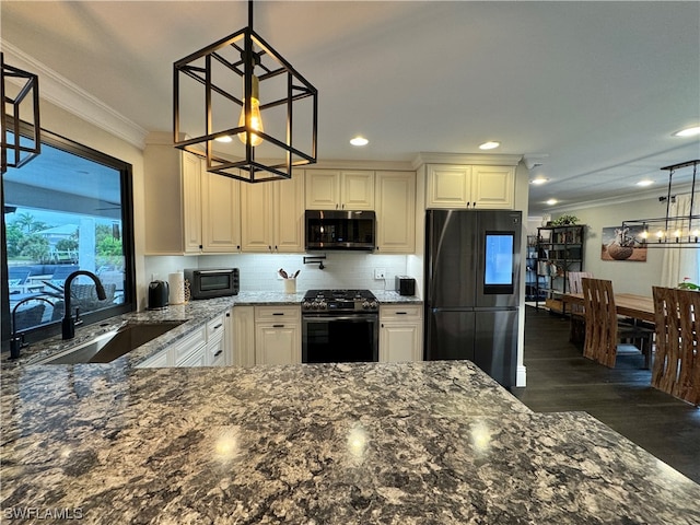 kitchen with dark hardwood / wood-style flooring, black appliances, decorative light fixtures, sink, and ornamental molding