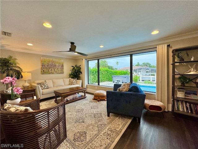 living room with crown molding, dark hardwood / wood-style floors, and ceiling fan