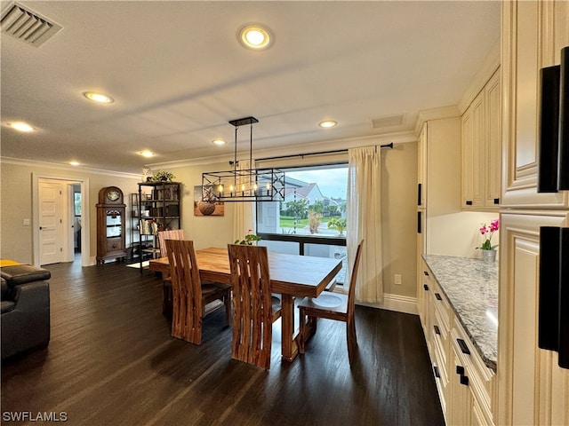 dining room with a chandelier, crown molding, and dark wood-type flooring