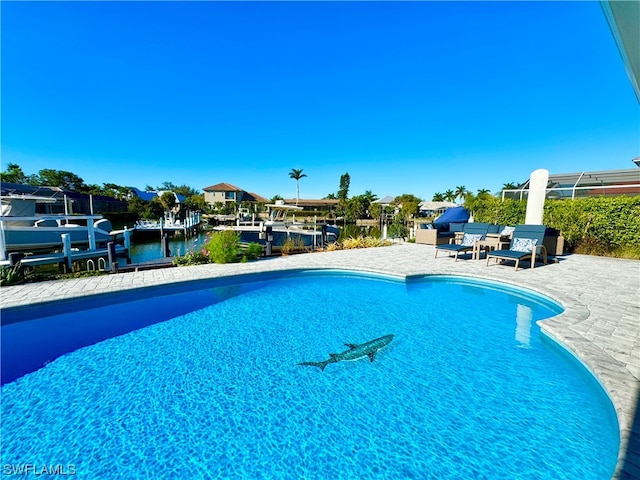 view of swimming pool featuring a water view and a patio