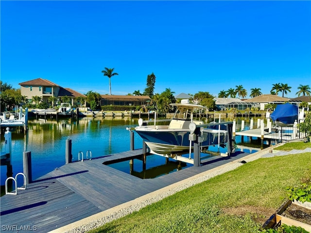 dock area with a yard and a water view