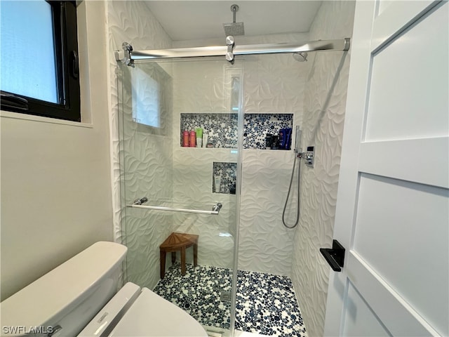 bathroom with an enclosed shower and toilet