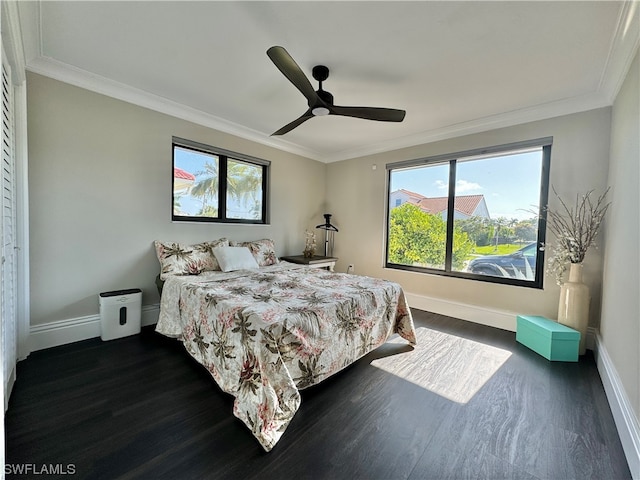 bedroom with ceiling fan, crown molding, and dark wood-type flooring