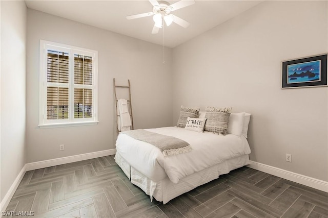 bedroom featuring a ceiling fan and baseboards