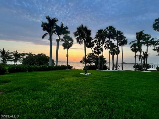 yard at dusk with a water view