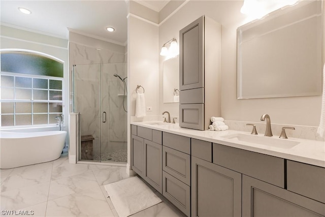 bathroom featuring marble finish floor, a marble finish shower, a sink, and a soaking tub