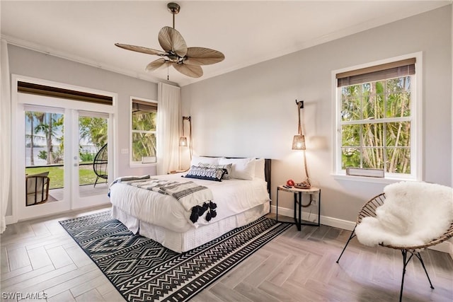 bedroom with access to exterior, multiple windows, crown molding, and baseboards