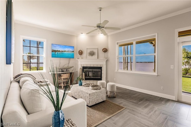 living room featuring crown molding, a fireplace, and baseboards