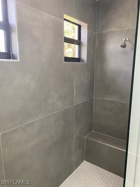 bathroom with a tile shower