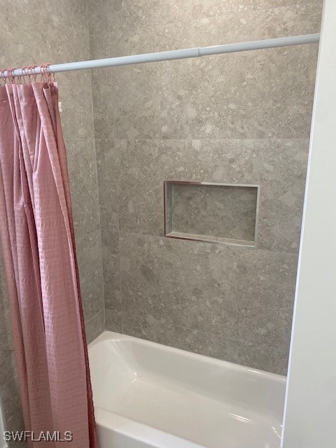 bathroom featuring shower / bath combination with curtain