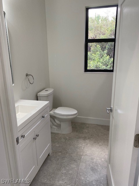 bathroom featuring toilet and vanity