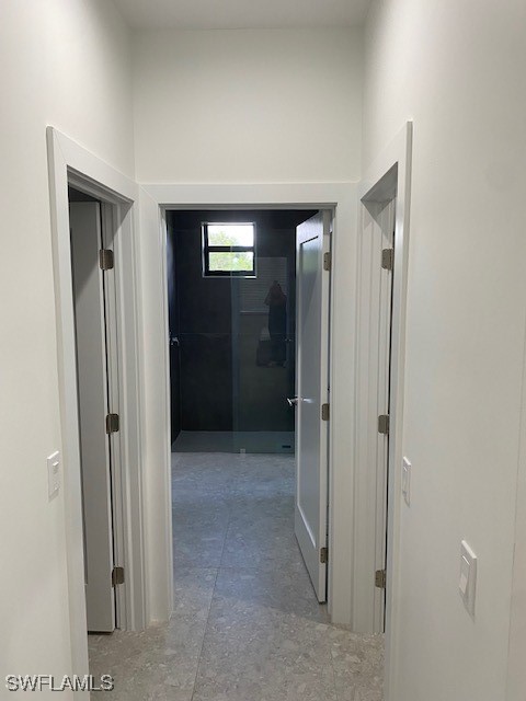 hallway featuring concrete flooring